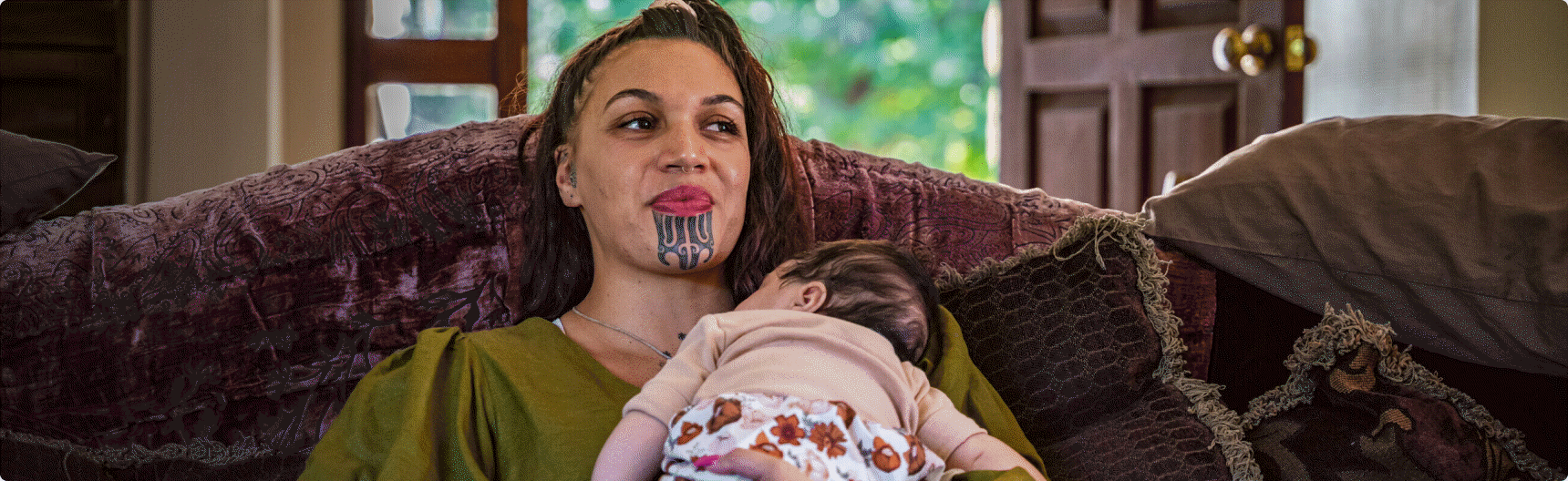 A mother holding her sleeping baby