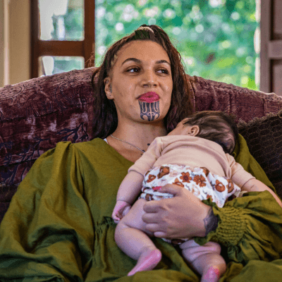 A mother holding her sleeping baby