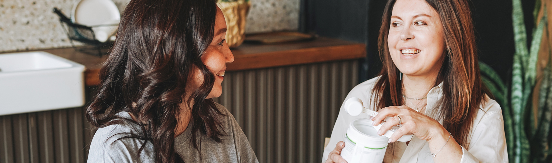 Two women talk with coffee