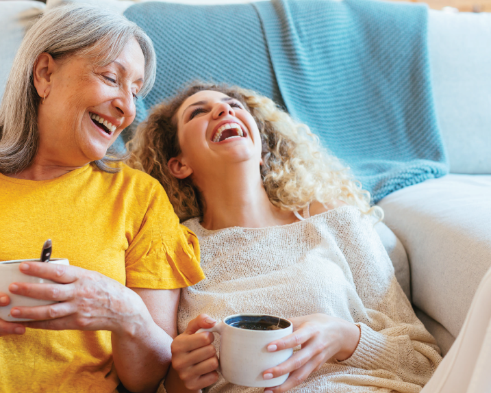 Two women laugh together 