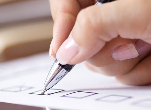 Southern Cross NZ - security compliance A hand ticking a box on a form